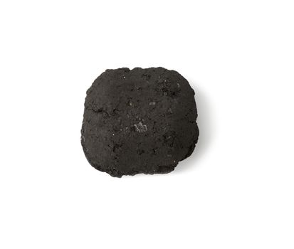 square piece of pressed charcoal for barbecue and bonfire isolated on a white background, ecological fuel