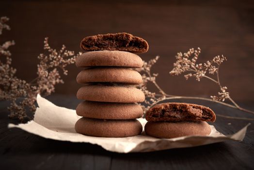 stack of round chocolate chip cookies on brown kraft paper, delicious dessert