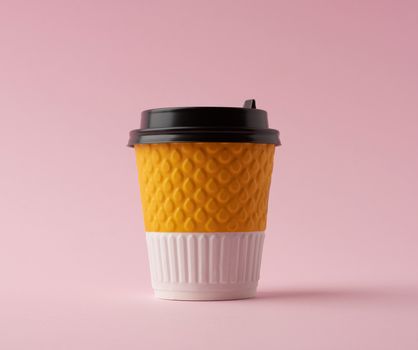 disposable hot drink paper cup with lid on a pink background, takeaway food