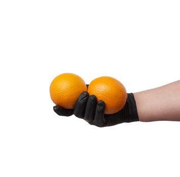 hand in a black latex glove holds two round ripe oranges, part of the body is isolated on a white background, concept of safe food delivery