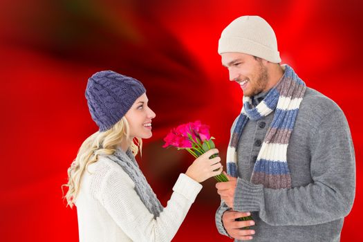 Composite image of attractive man in winter fashion offering roses to girlfriend