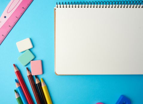 open notebook in the middle with blank white sheets, top view, concept of back to school, flat lay