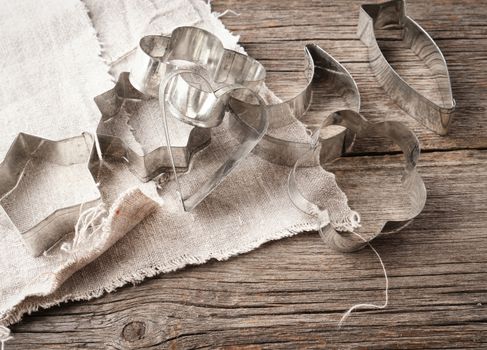 vintage metal molds for making cookies on a gray wooden background, close up
