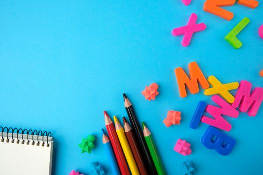 notebook  with blank white sheets, multicolored wooden pencils , top view, concept of back to school, flat lay