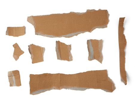 pieces of cardboard corrugated paper torn edges on a white background, abstract backdrop. Ripped paper texture