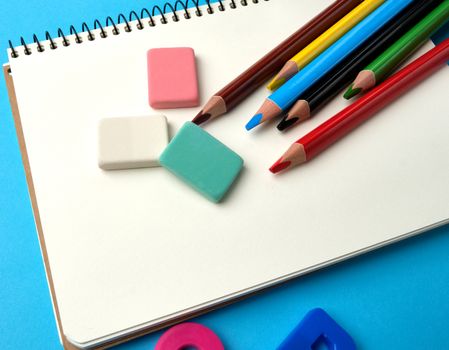 open notebook in the middle with blank white sheets, top view, concept of back to school, flat lay