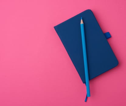 blue notebook on a pink background, backdrop for the designer