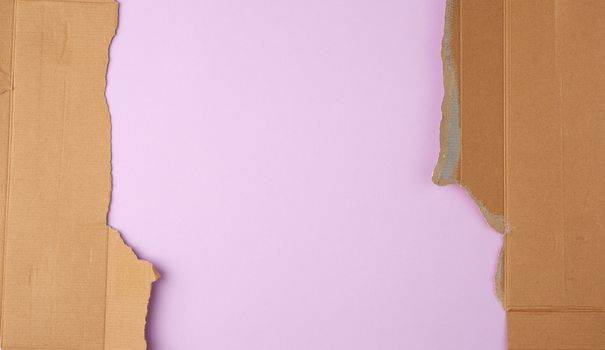 torn edges of corrugated cardboard paper with purple background, abstract backdrop template