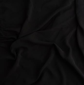 texture of black synthetic fabric with waves, full frame, fabric for sewing clothes, shirts. Design Element