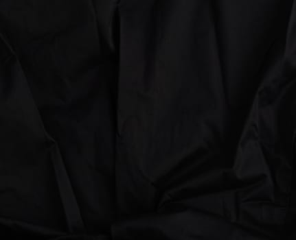 texture of black cotton fabric with waves, full frame, fabric for sewing clothes, shirts. Design Element