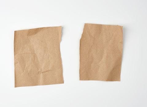 crumpled blank sheet of brown wrapping kraft paper with torn edges, vintage texture for the designer.  Torn paper sheet