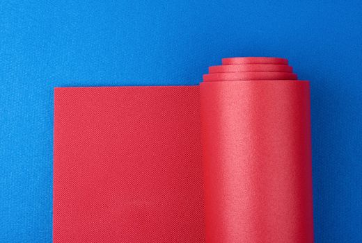 neoprene red twisted mat lies on a blue mat, sports equipment, copy space