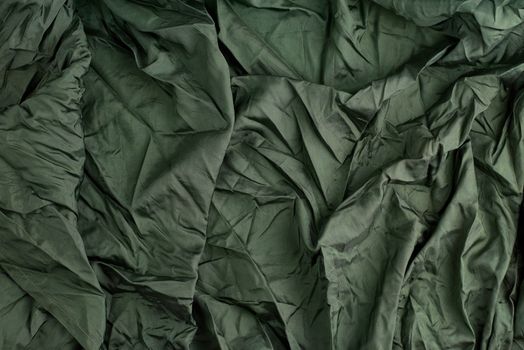 green satin textile fabric, piece of fabric for sewing curtains and things, full frame