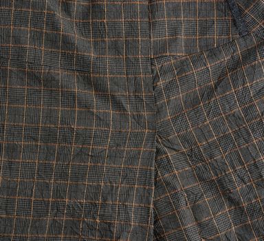 textile gray wool checkered fabric, fabric for tailoring suits and skirts, close up