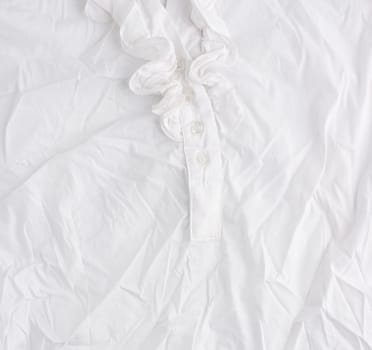 fragment of a white cotton blouse with buttons, full frame