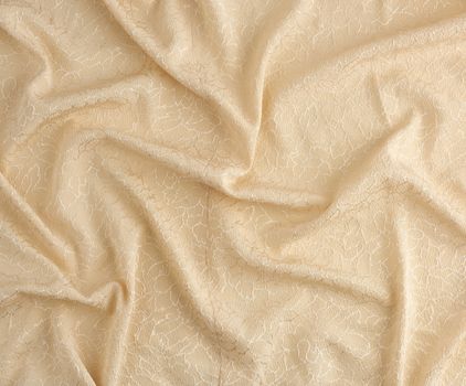 beige satin textile fabric with embroidery elements, piece of canvas for sewing curtains and things, full frame. Crumpled textile satin, great design for any purposes.