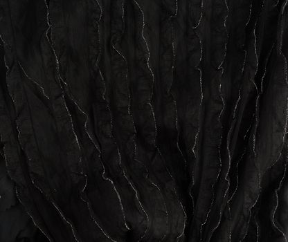 texture of black cotton fabric with waves, full frame, fabric for sewing clothes, shirts. Design Element, shiny silver ruffles