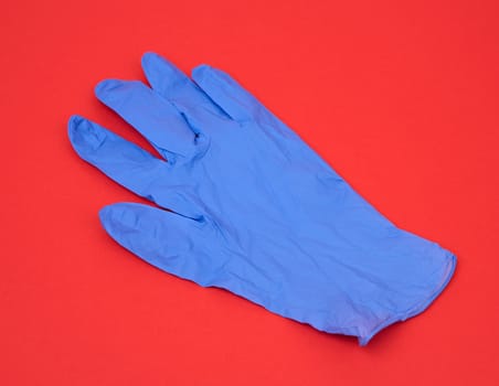 blue medical rubber glove for carrying out procedures and manipulations, subject is isolated on a white background