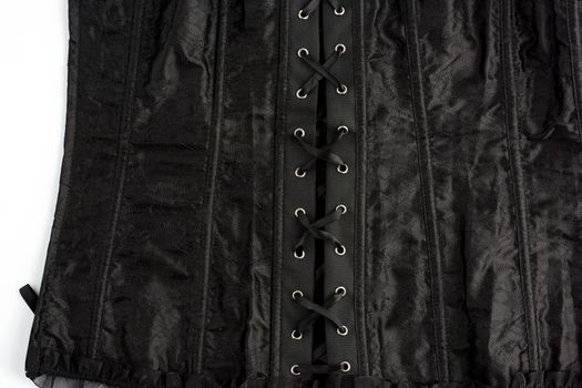 fragment of a black satin corset with lacing, back view, clothing item, close up