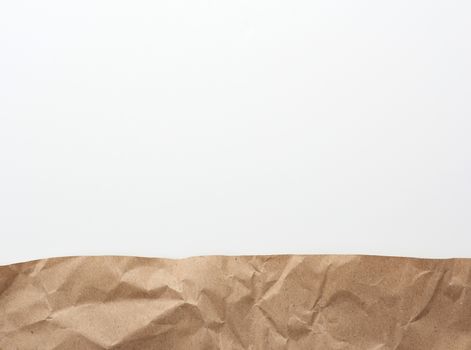 brown pieces of parchment paper on a white background, flat lay, copy space