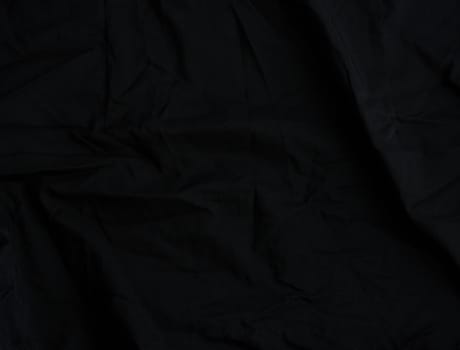 texture of black cotton fabric with waves, full frame, fabric for sewing clothes, shirts. Design Element