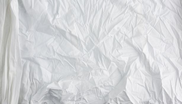 crumpled white cotton fabric, fabric for sewing clothes and shirts, full frame