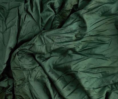 green satin textile fabric, piece of fabric for sewing curtains and things, full frame