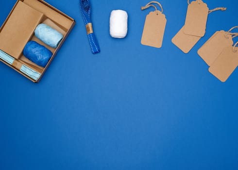 set for packing holiday gifts on a blue background, top view, copy space