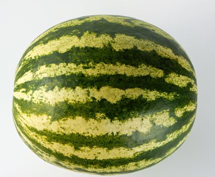 big green striped whole watermelon on a white background, summer berry