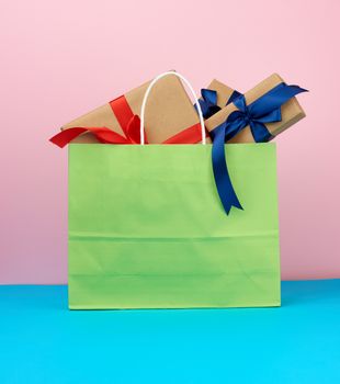 pink paper bag with a gift box, concept of shopping and giving a gift