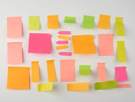 multicolored blank paper stickers of different sizes and shapes on a white background