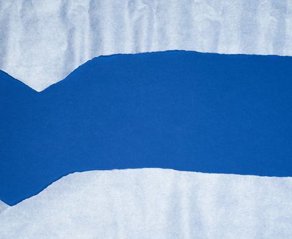 blue background with white crumpled torn paper elements, place for writing op in the middle, template