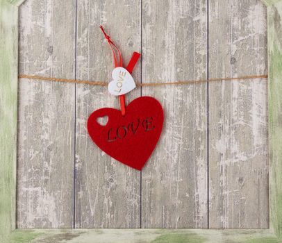 red felt heart hanging on a brown rope, backdrop for Valentine's Day