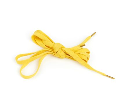 pair of yellow textile shoelaces tied on a white background, object is isolated