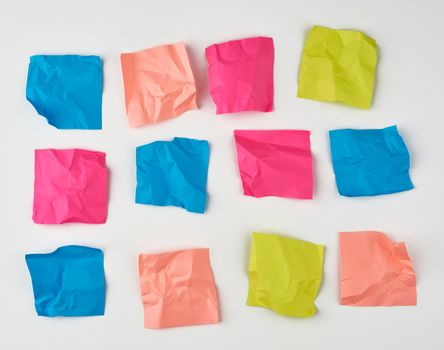 multicolored blank crumpled paper stickers of different sizes on a white background