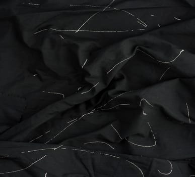 texture of black cotton fabric with waves, full frame, fabric for sewing clothes, shirts. Design Element