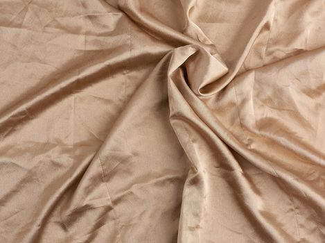 beige satin textile fabric, piece of canvas for sewing curtains and things, full frame. Crumpled textile satin, great design for any purposes.