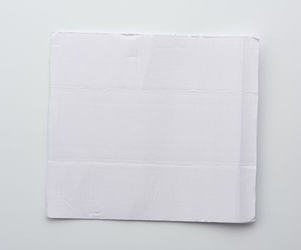 white blank corrugated paper sheet on white background, close up