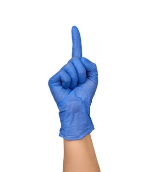female hand in a blue medical sterile glove shows a gesture, the index finger is raised up, part of the body is isolated on a white background, attention concept