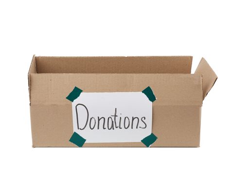 empty brown cardboard box with a pasted white sheet and the inscription donations on a white background, help concept