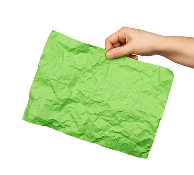 female hand hold empty crumpled green rectangular sheet of paper a4, white background 
