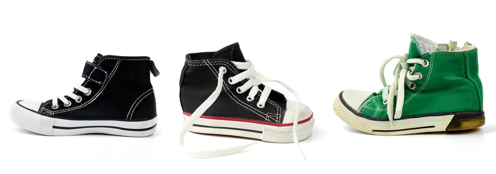black, green textile sneakers  with white tied shoelaces on a white background, shoes stand sideways