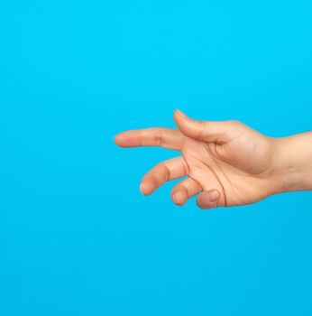 hand reaches to the side, gesture that shows holding the item in the palm, blue background