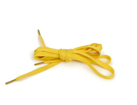 pair of yellow textile shoelaces tied on a white background, object is isolated