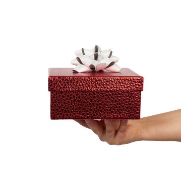 hand hold a wrapped gift with tied silk bows, subject is isolated on a white background, concept of surprise and gift for the holiday