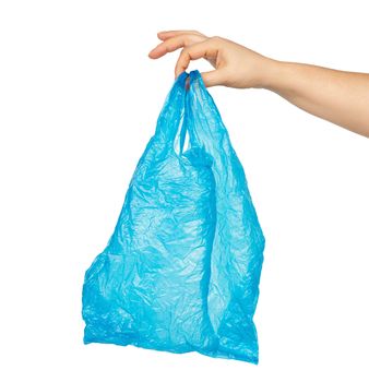 hand holds an empty blue plastic bag on a white background, concept of rejection of plastic and the transition to eco-packaging