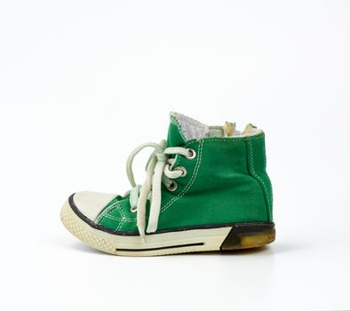 green textile sneaker with white tied shoelaces on a white background, shoes are sideways