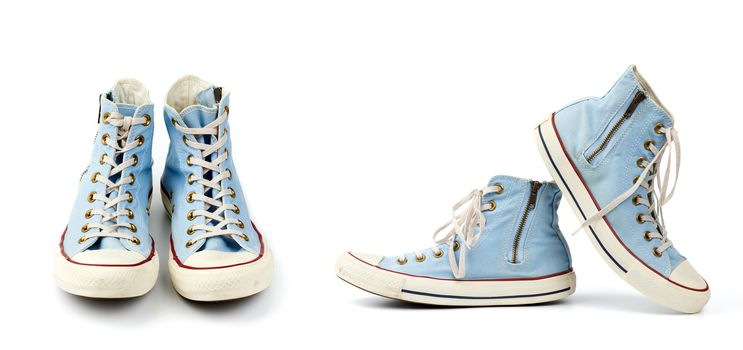 pair of light blue worn textile sneakers with laces and zippers on a white background, side view of shoes and front view, set