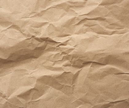 fragment of crumpled blank sheet of brown wrapping kraft paper, vintage texture for the designer, full frame