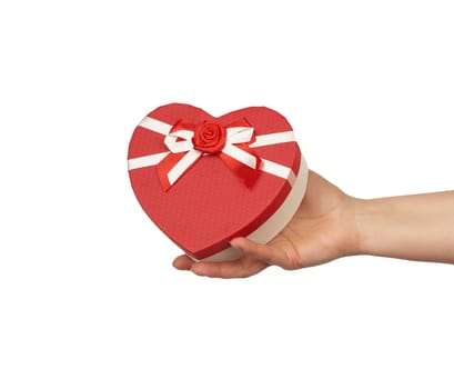 hand hold a red gift box with tied silk bows, subject is isolated on a white background, concept of surprise and gift for the holiday